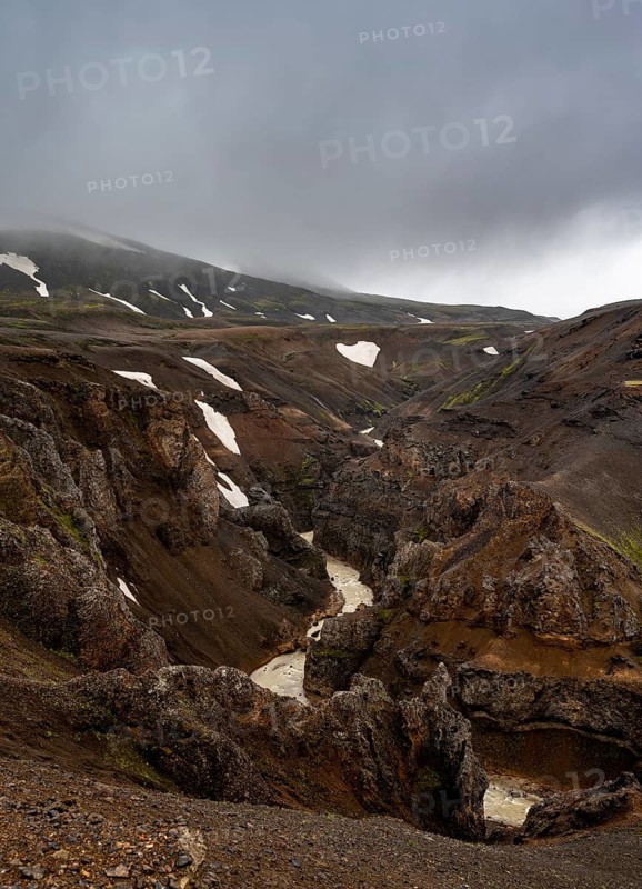 River in a gorge, foot of Asgardsa, volcanic landscape with black and red rocks, Kerlingarfjöll, Icelandic highlands, Iceland
