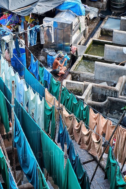 MUMBAI, INDIA, OCTOBER 31, 2019: Dhobi Ghat (Mahalaxmi Dhobi Ghat) is open air laundromat lavoir in Mumbai, India with laundry drying on ropes. Now signature landmark tourist attractions of Mumbai