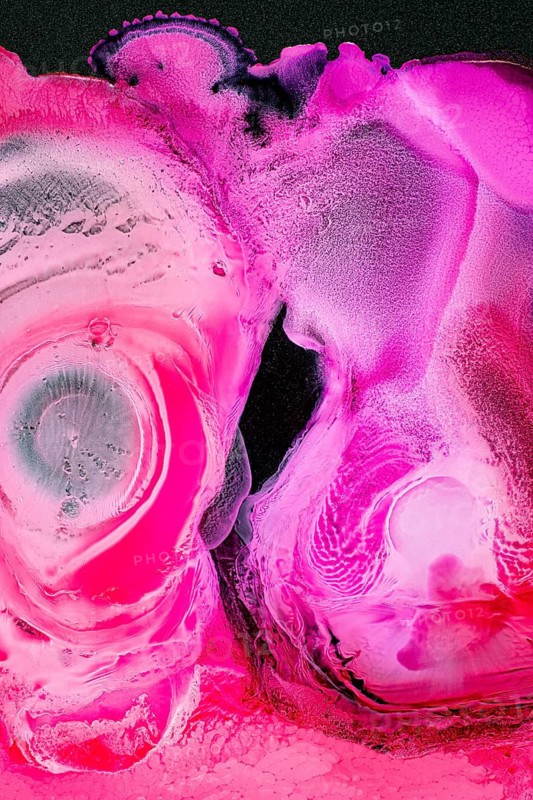 An abstract image showcasing a vivid pink texture with liquids shapes. The vibrant colors and dynamic composition evoke a sense of energy and movement in the galaxy