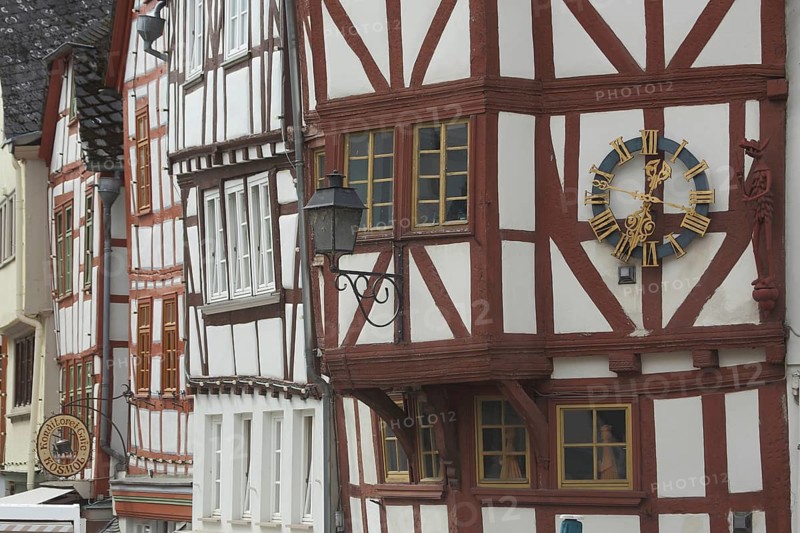 Half-timbered houses with clock and nose sign, front of houses, Bischofsplatz, Limburg, Hesse, Germany