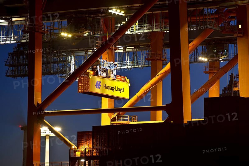 A Hapag-Lloyd container on the container gantry crane in the evening, Eurogate container terminal, Port of Hamburg, Germany