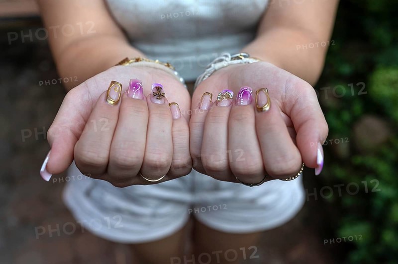 Colourful fingernails of a young woman, on a black background, Baden-Württemberg, Germany