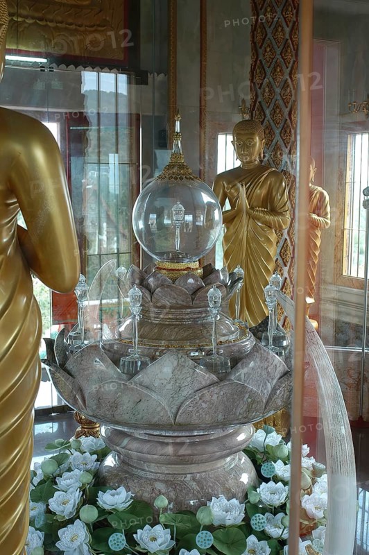 Praying Buddha statues and stylised lotus blossom in relic room with relics under glass in dome of tower in top of chedi highest building in temple complex Buddhist monastery Wat Chalong Wat Chaitararam, Phuket, Thailand