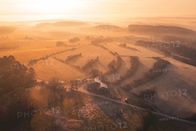 Aerial view with golden landscape, fog and a homestead in morning light, Gechingen, Calw district, Germany
