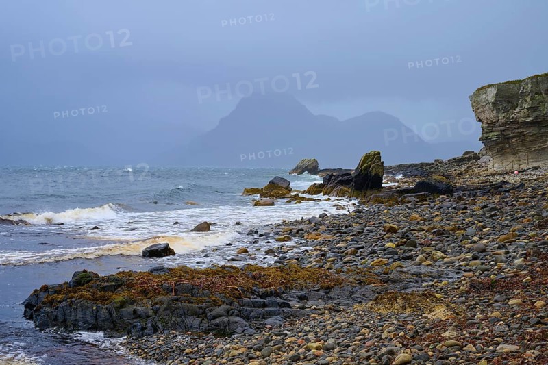 Rocky shoreline at sea under a cloudy sky with waves, Elgol Beach, Elgol, Isle of Skye, Scotland, United Kingdom, Great Britain