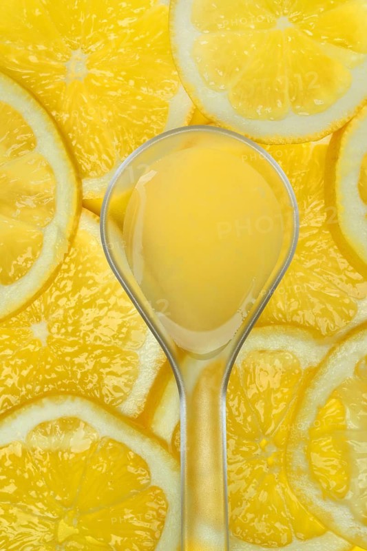Lemon juice in ladle and lemon slices, Citrus x limon