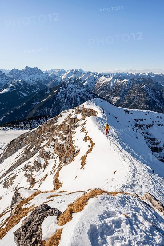 Two ski tourers at the summit of Schafreuter, view of snowy mountain panorama, Karwendel, Tyrol, Austria