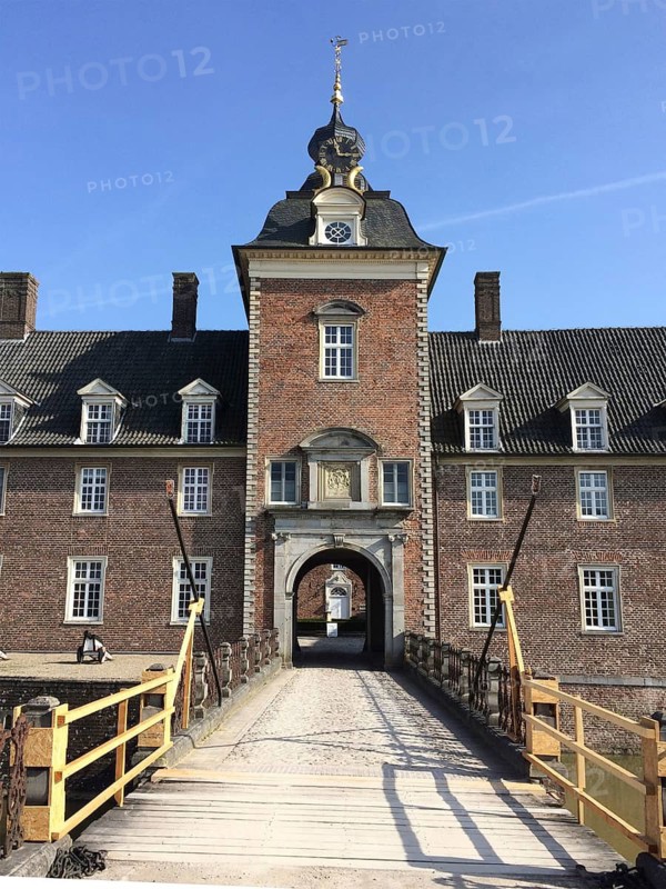 Portal tower with entrance gate on west side of historic moated castle moated castle Schloss Anholt, in the foreground former drawbridge, Isselburg, North Rhine-Westphalia, Germany