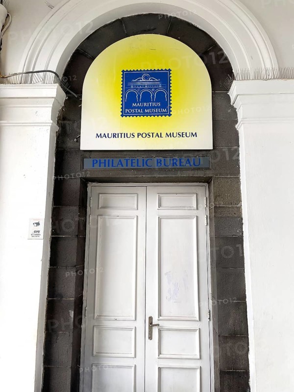 Entrance and logo sign to Mauritius Postal Museum Philatelic Bureau with Blue Mauritius stamp, Port Louis, Mauritius