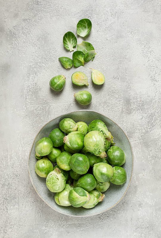 Fresh Brussels sprouts, raw, top view, on a gray table, no people