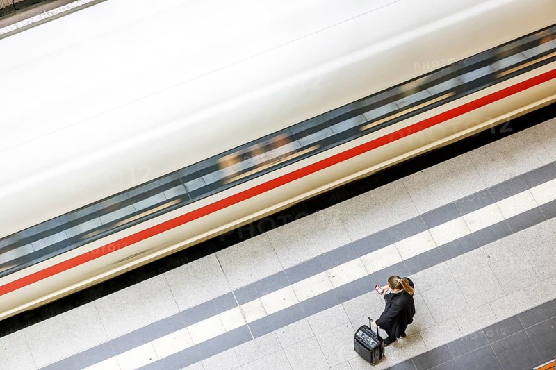 Berlin Central Station with ICE. There is a woman standing on the platform with a cell phone. Berlin, Germany