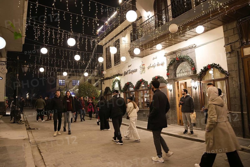 In Damascus, Syria, on December 25, 2025, festive scenes filled the streets and churches of the Bab Touma district, where thousands of people gathered to celebrate Christmas Eve amid holiday decorations and lights, Damascus, Damascus, Syria