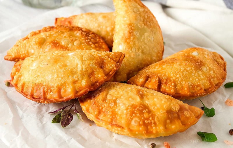 Fried chebureks, close-up, on a light background, no people
