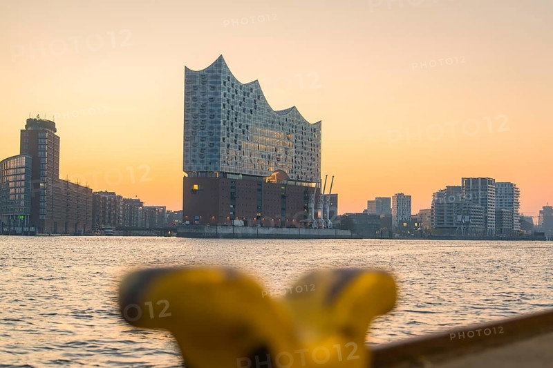 Blurred close-up of the Elbphilharmonie at sunrise by a river, Hamburg, Germany