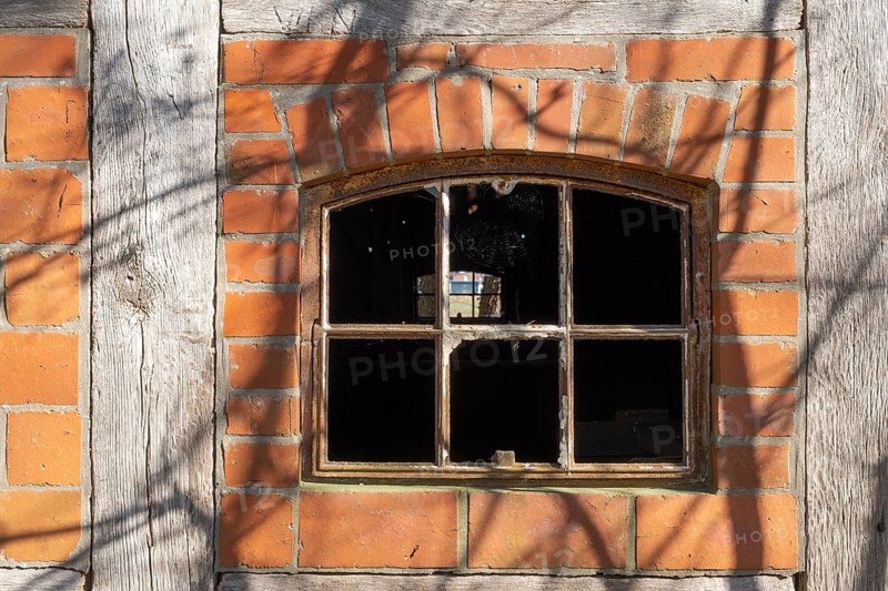 An old rusty window frame of a half-timbered barn, Wildeshauser Geest, Bassum, Diepholz, Lower Saxony, Germany