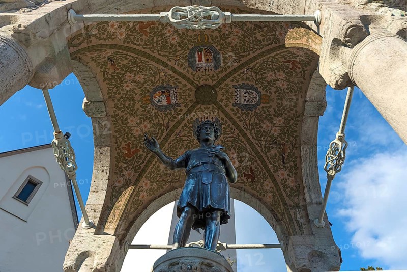 Sculpture of St. Magnus of Füssen, who is the apostle of the Allgäu, under a canopy, St. Mang Fountain, Kempten (Allgäu), Bavaria, Germany