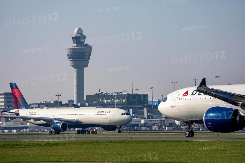 Delta Air Lines Airbus A330-300 on the taxiway to the Aalsmeerbaan runway, and at takeoff, Amsterdam Schiphol Airport, terminal, air traffic control tower, AMS, Netherlands