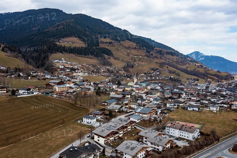 Drone shot, view of village with parish church, Piesendorf, Pinzgau, Salzburg province, Austria