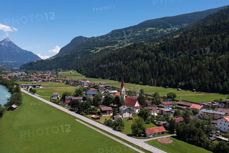 Drone shot, view of village with parish church, Schönwies, Oberinntal, Tyrol, Austria