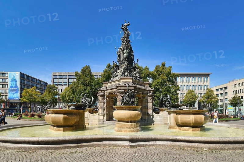 Mannheim, Germany, September 2021: Fountain with sculptures called 'Grupello Pyramid' with sculptures in square called 'Paradeplatz' in city center