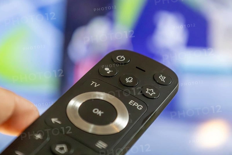 Close-up of a remote control during a broadcast of the Olympic Games in Milan/Cortina