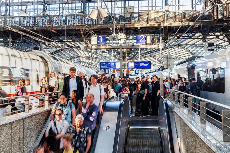 Cologne Central Station. Stairs to the platforms. Travellers waiting for their train on the platform. Crowd with motion blur. Cologne, North Rhine-Westphalia, Germany