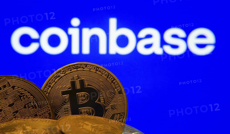 Dhaka, Bangladesh- 16 June 2025: Close-up of Bitcoin coins with the Coinbase logo visible on a screen in the background