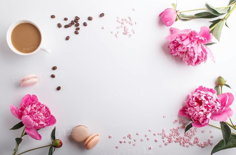 Pink peony flowers and a cup of coffee on a white background. Morninig, spring, fashion composition. Flat lay, top view, copy space