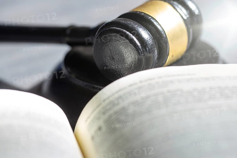 Symbolic picture court hearing: close-up of a judge's hammer and the civil code
