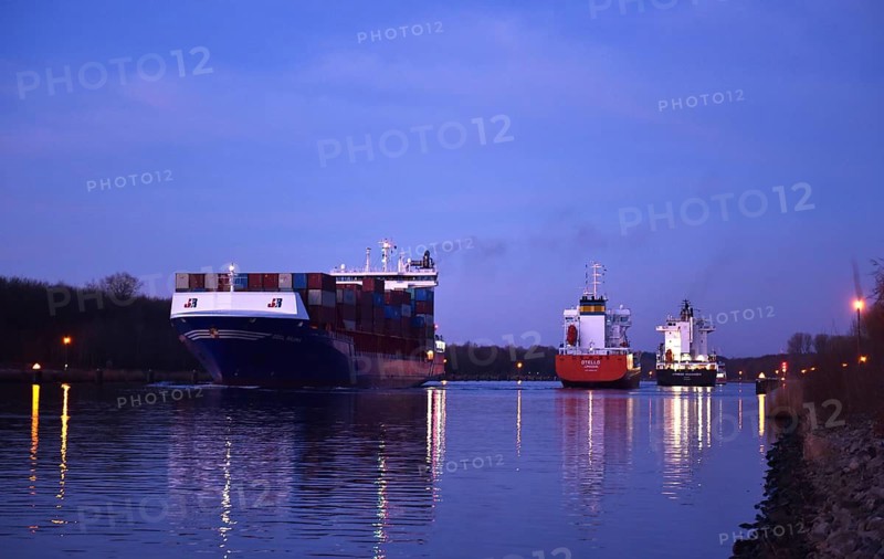 Container ship OOCL RAUMA at the blue hour, sunrise in the Kiel Canal, NOK, Kiel Canal, Schleswig-Holstein, Germany