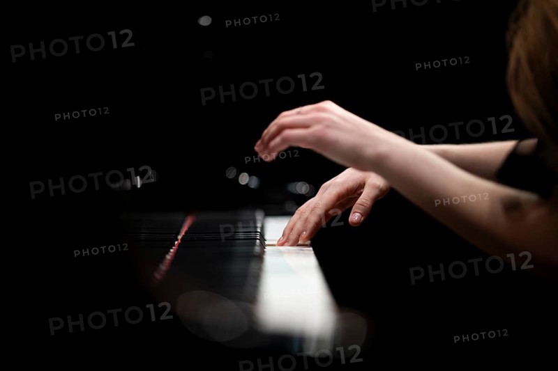 Hands and arms of a young pianist playing on the keyboard of a Steinway & Sons grand piano, Stuttgart, Baden-Württemberg