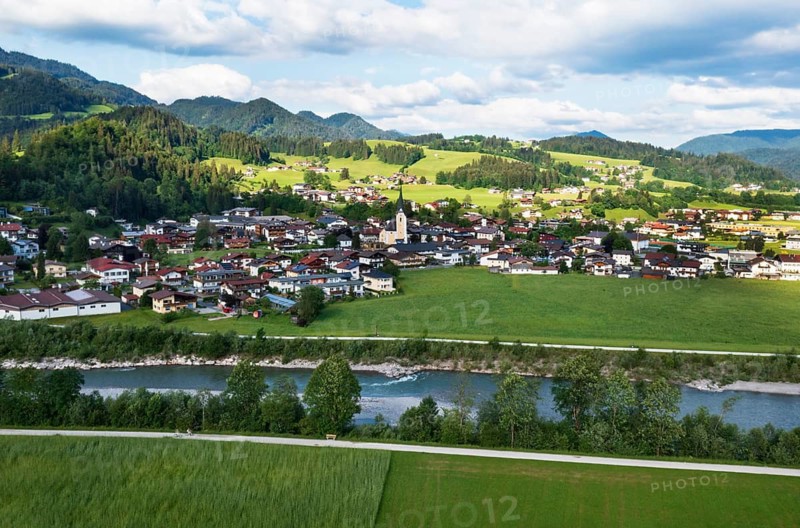 Drone shot, view of the village with parish church, Kössen, Leukental, Tyrol, Austria