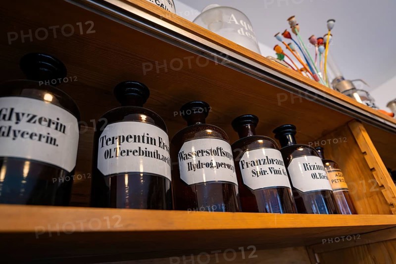 Shelf with labelled glass pharmacy bottles in an old pharmacy, Calw Tannery Museum, Black Forest, Germany