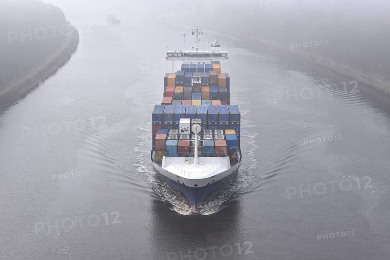 Container ship BALTIC WHALE sails through the Kiel Canal in fog, NOK, Kiel Canal, Kiel Canal, Schleswig-Holstein, Germany