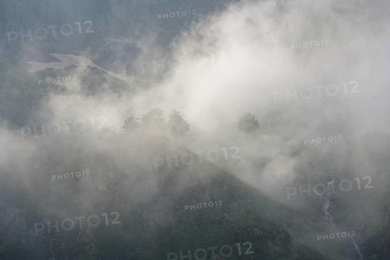 Clouds move over the mountains after a rain shower at Lago della Rovina, Entracque, province of Cuneo, Italy