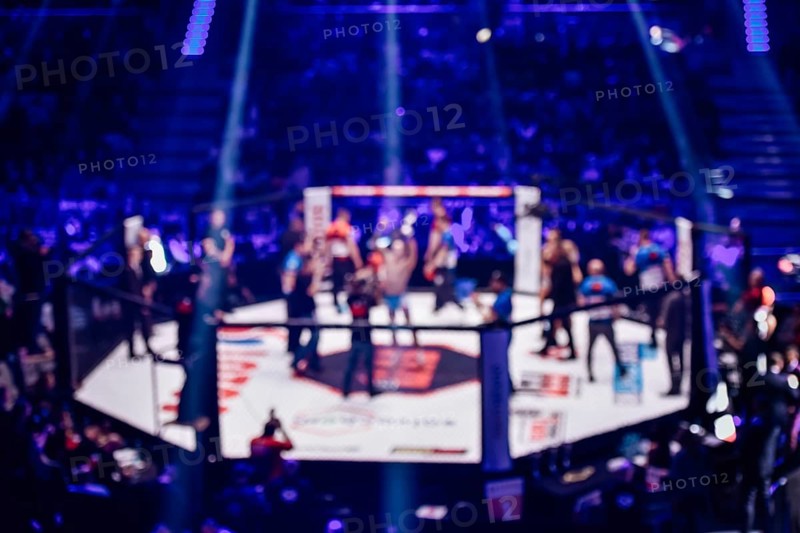 Blurred background of mma fight ring with fighter champion decoration