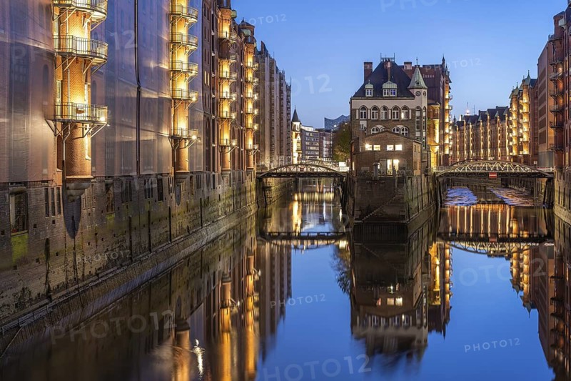 Water castle in Hamburg's Speicherstadt at the blue hour and reflection in the water, Hamburg, Germany