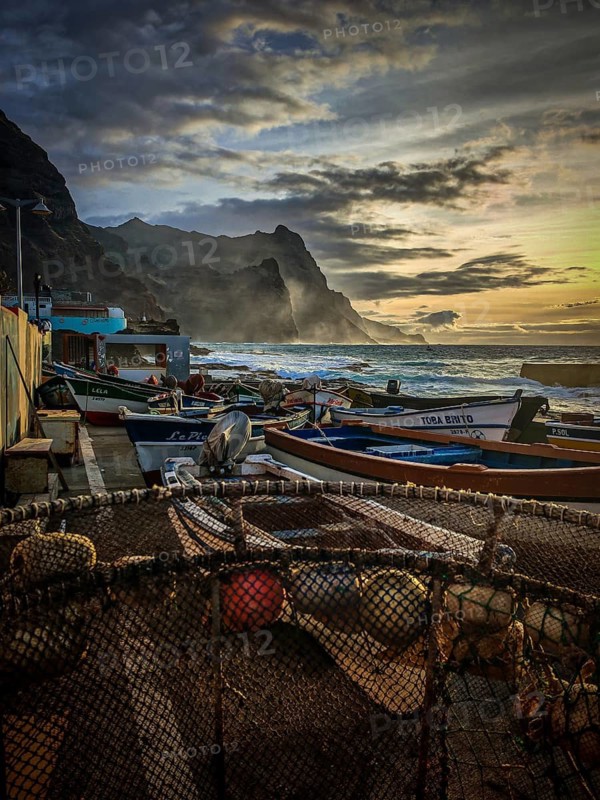Fishing boats along a rocky stretch of coast at sunset with dramatic clouds, romantic harbor scene, Ponta do Sol, Santo Antao, Cabo Verde, Cape Verde, Cape Verde