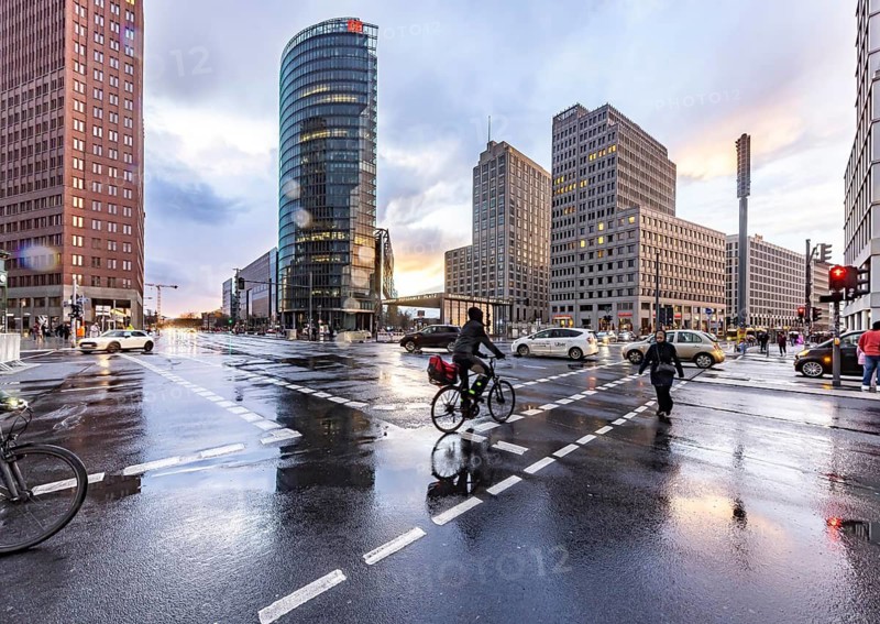 Potsdamer Platz Berlin in the evening with traffic on the streets. When it rains, the skyscrapers are reflected in puddles of water. Berlin, Germany