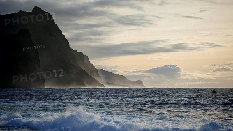 Stormy sea, dusk with silhouette of mountains in the background under a cloudy sky, Ponta do Sol, Santo Antao, Cabo Verde, Cape Verde