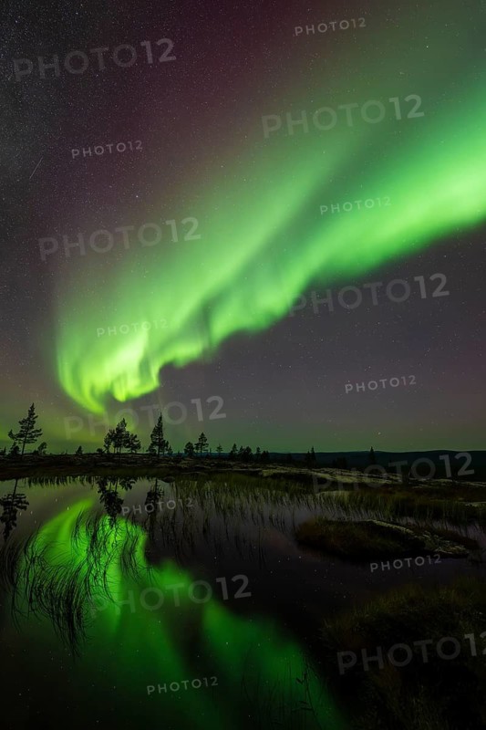 Northern Lights (Aurora borealis) reflected in a mountain lake, Norrbotten, Lapland, Sweden, September 2024