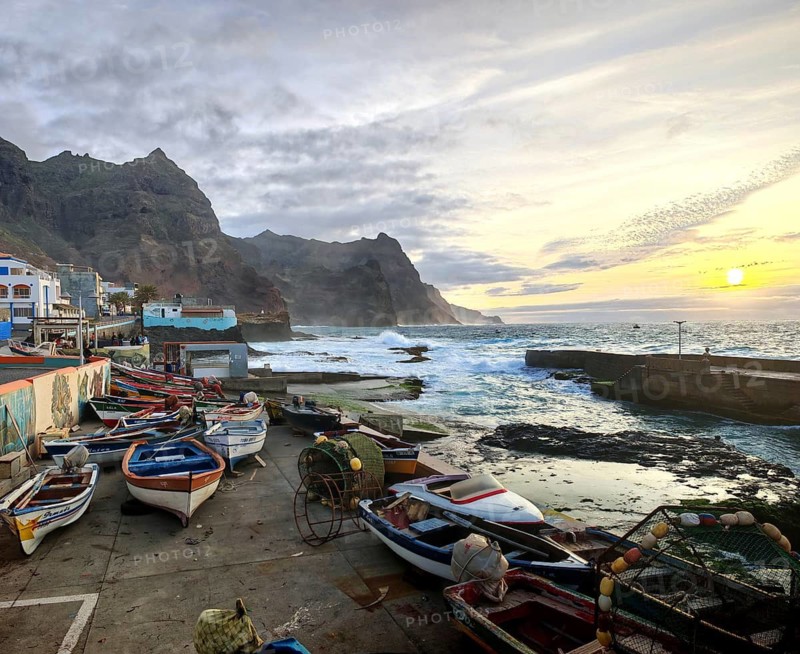 Fishing boats rest on the pier during a peaceful sunset, Ponta do Sol, Santo Antao, Cabo Verde, Cape Verde, Cape Verde