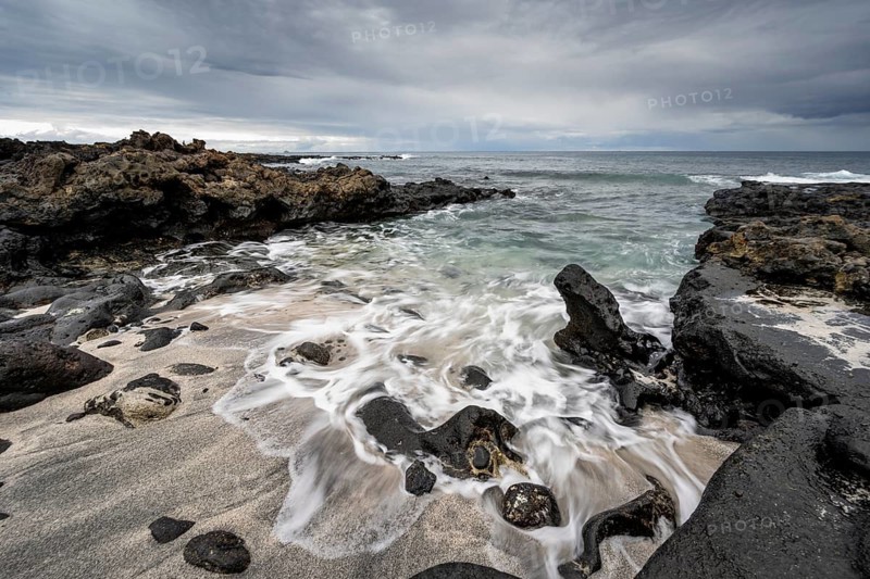 Waves blaze on the beach, rocky coast with volcanic stones, long exposure, Playa de la Pequeña, Punta Usaje, Lanzarote, Canary Islands, Spain