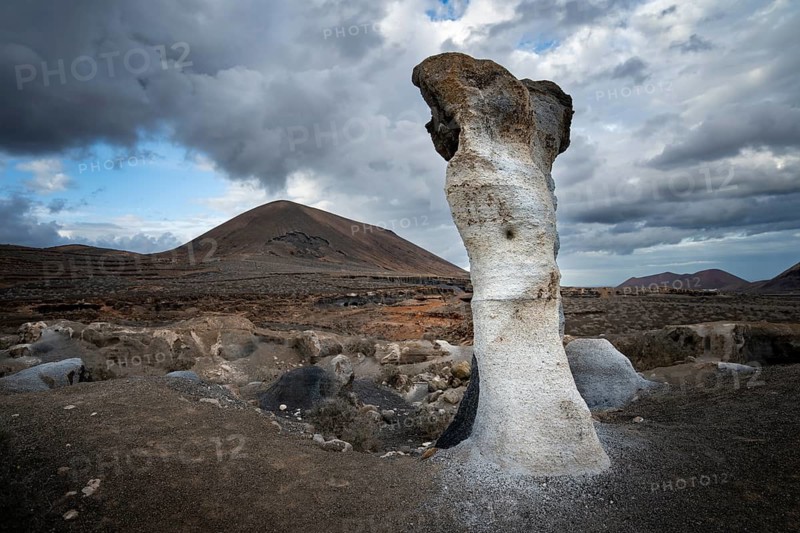 Eroded rock formations, volcanic landscape with dramatic cloudy skies, Ciudad Estratificada or Los Roferos, Antigua Rofera de Teseguite, Lanzarote, Canary Islands, Spain