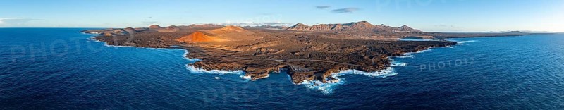 Coast with lava fields, volcanic landscape near Los Hervideros with red volcano Montaña Bermeja, in the evening light, aerial view, Lanzarote, Canary Islands, Spain