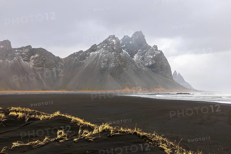 Sand dunes covered with rotten grass, lava sandy beach against mountain backdrop, winter, Stokksnes, Vestrahorn, Klifatindur, Höfn, Iceland, Scandinavia