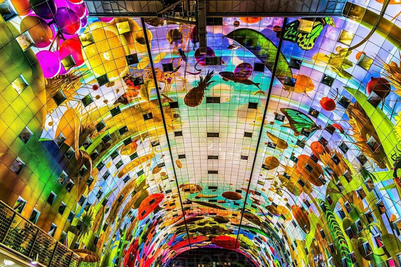 Markthal from 2014, offers over 100 food stalls and delicatessens with spectacular ceiling fresco cornucopia, Horn of Plenty by Arno Coenen and Iris Roskam, Rotterdam, the Netherlands
