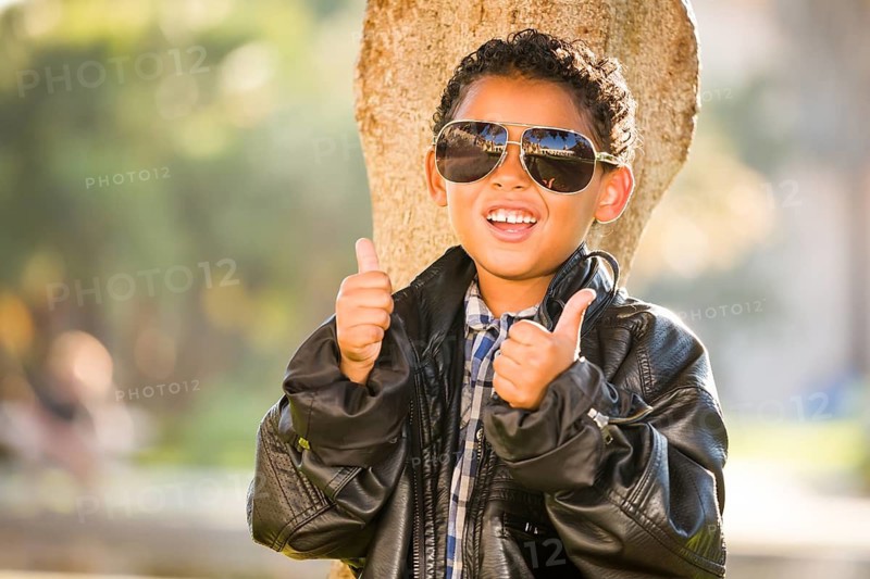 African American and Mexican Boy Dressed Up with Sunglasses and Leather Jacket