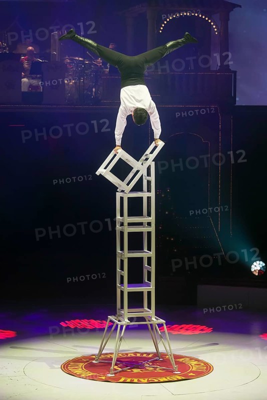 Artist on chairs at the Roncalli Christmas Circus in Berlin's Tempodrom on 20 December 2024