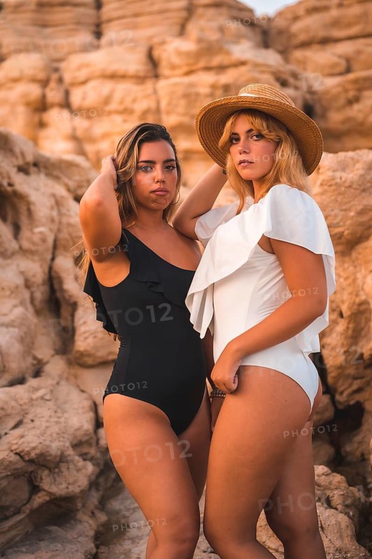 Lifestyle of a couple of Caucasian lesbian girls posing on the beach in summer